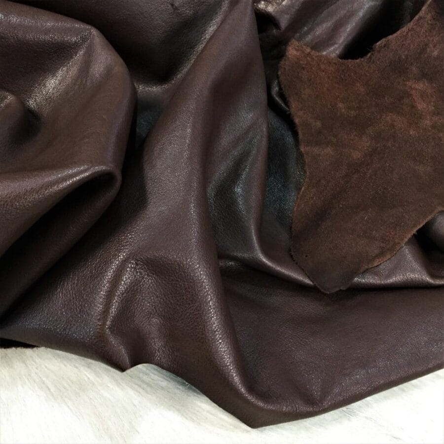 Draped brown buffalo hide showing its grain and suede reverse