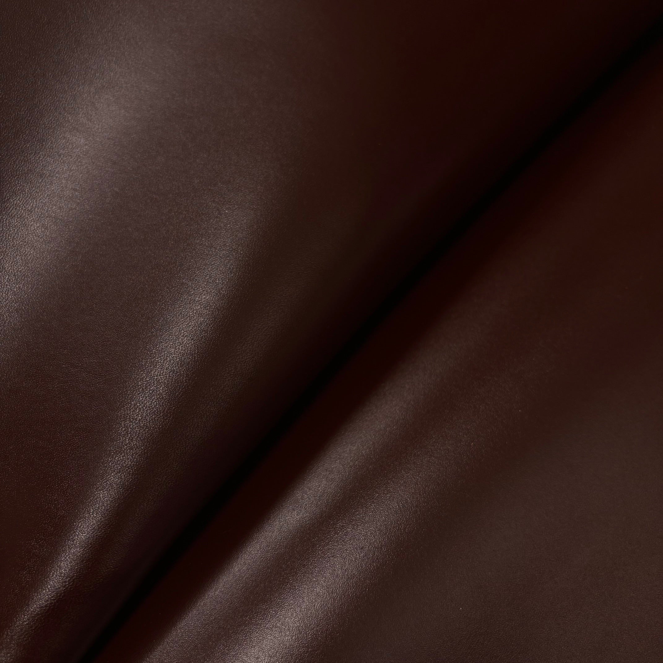 Brown smooth calf leather draped in a soft fold